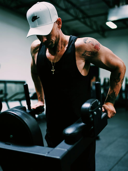 man in black tank top wearing white cowboy hat