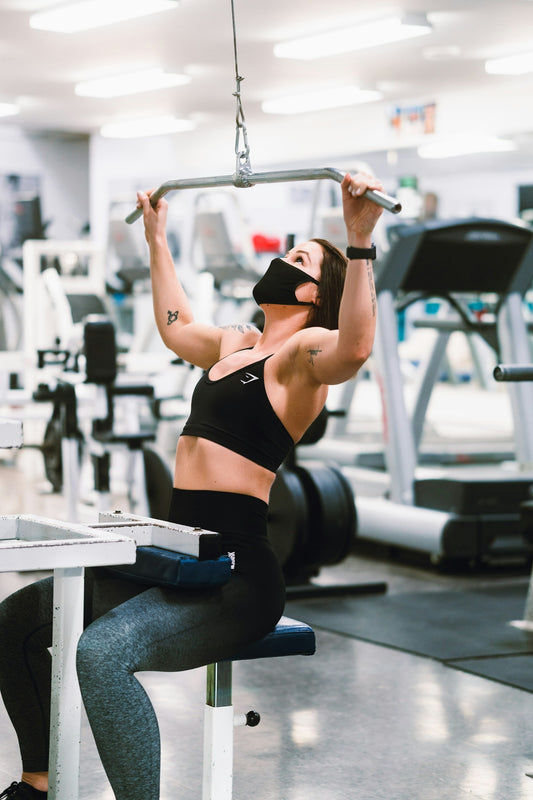 woman in black sports bra and blue denim jeans doing exercise