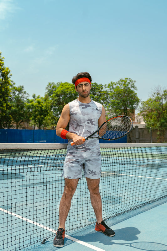 a man holding a tennis racquet on a tennis court