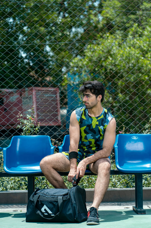 a man sitting on a bench with a bag