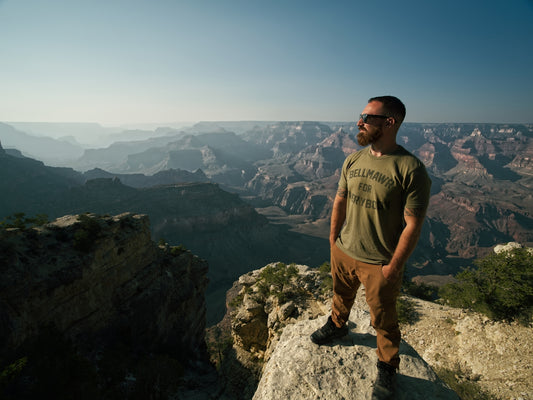 a man standing on top of a large cliff