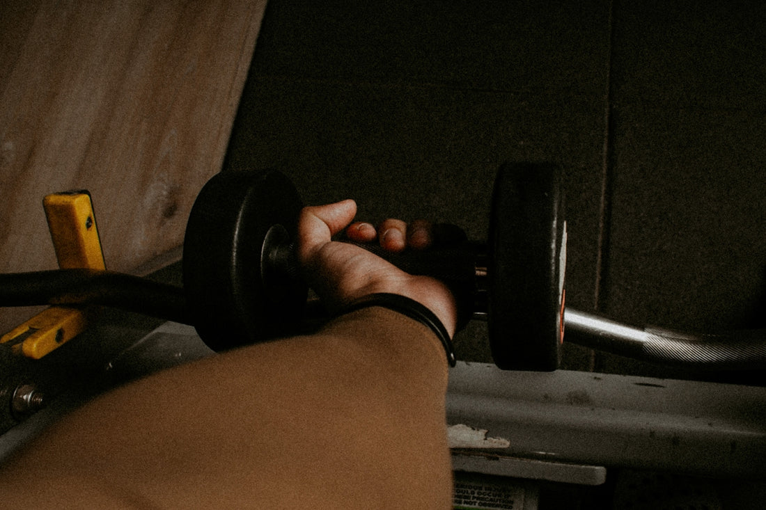 a person lifting a barbell in a gym