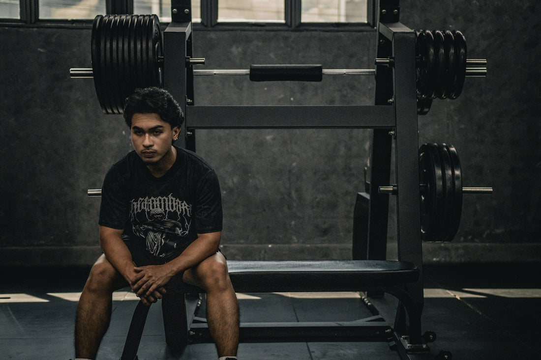 A man sitting on a bench in a gym