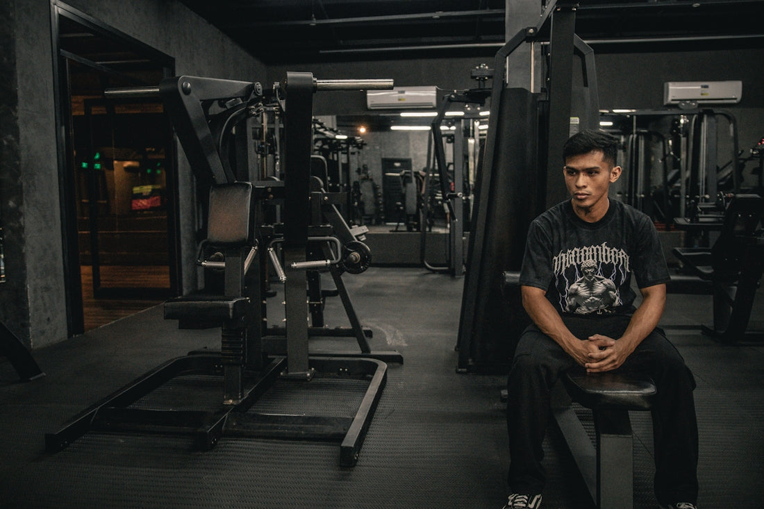 A man sitting on a bench in a gym