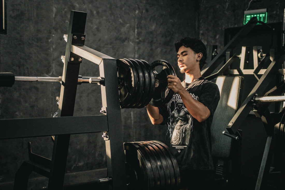 A man holding a camera in a gym