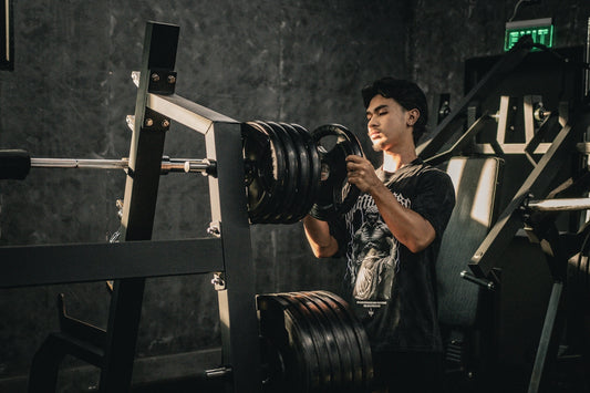 A man holding a camera in a gym