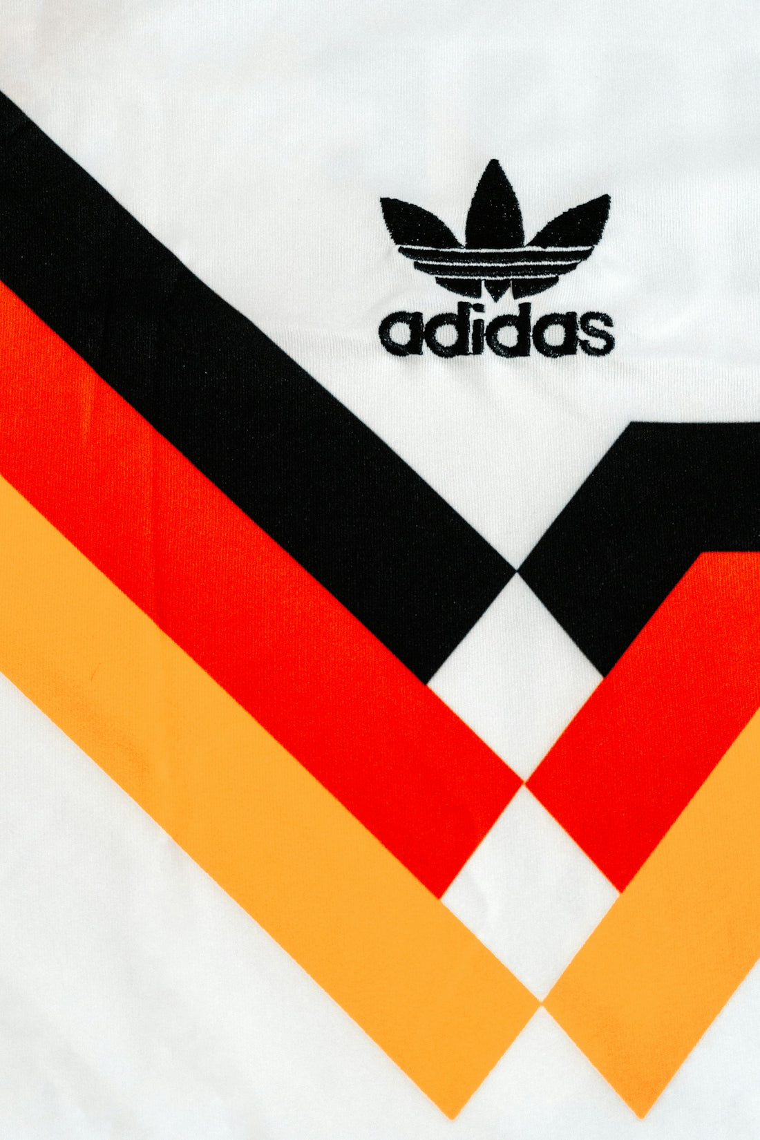 White jersey with adidas logo and german flag colors