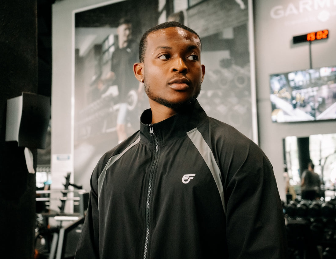 Man in gym wearing athletic jacket