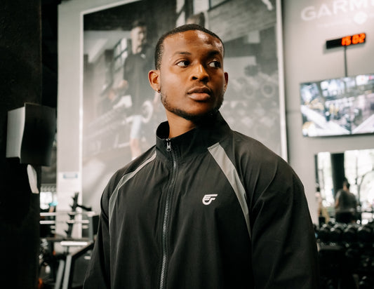 Man in gym wearing athletic jacket