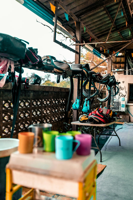 Colorful mugs and cycling gear displayed outdoors