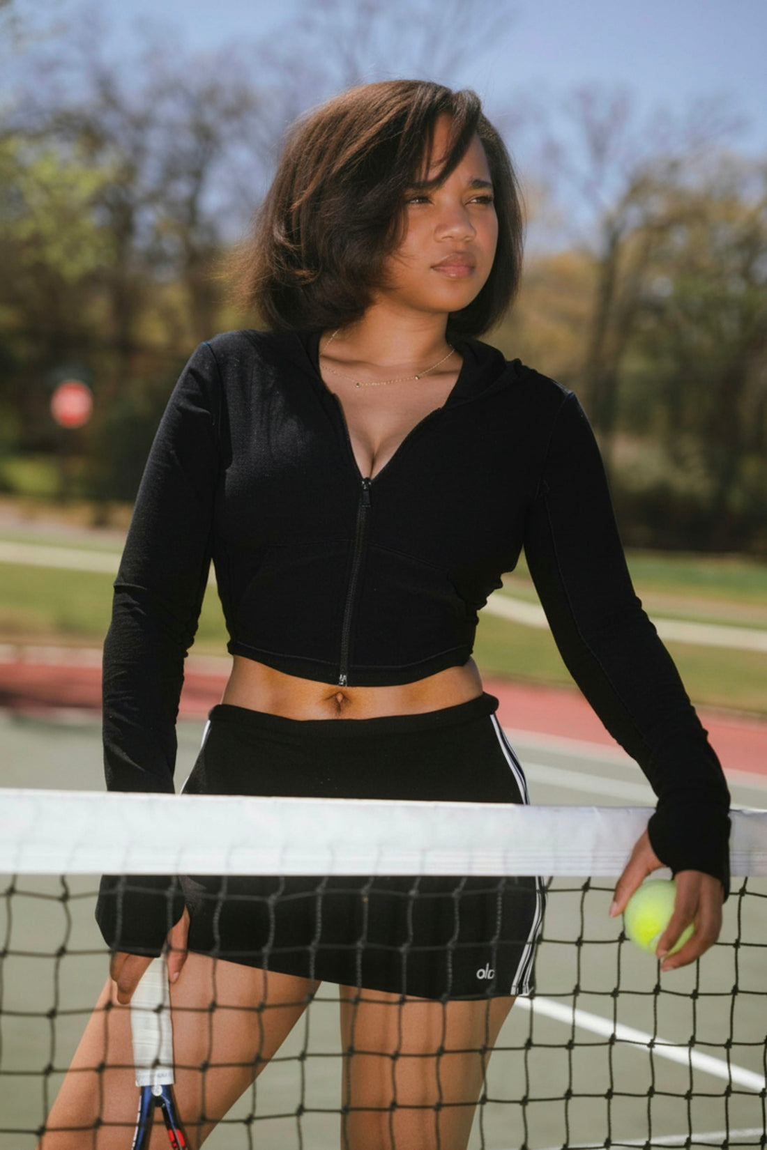 Young woman on a tennis court holding a racket