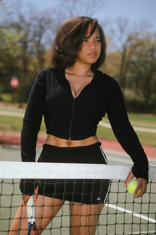 Young woman on a tennis court holding a racket