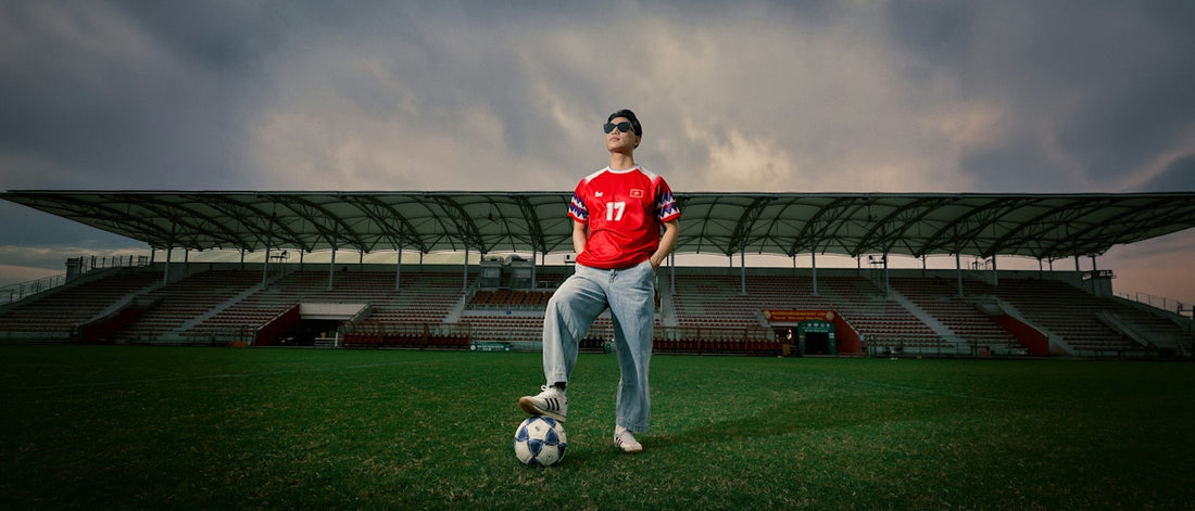 Soccer player with foot on ball in an empty stadium